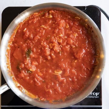 Tomatoes simmering in a sauce pan.
