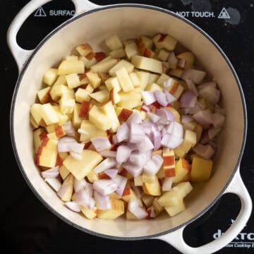 Sauteing apples and shallots in dutch oven.