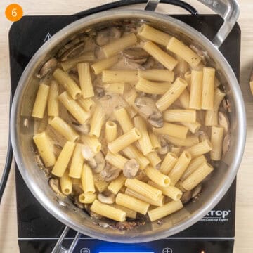 Pasta added to sauce in the pan.