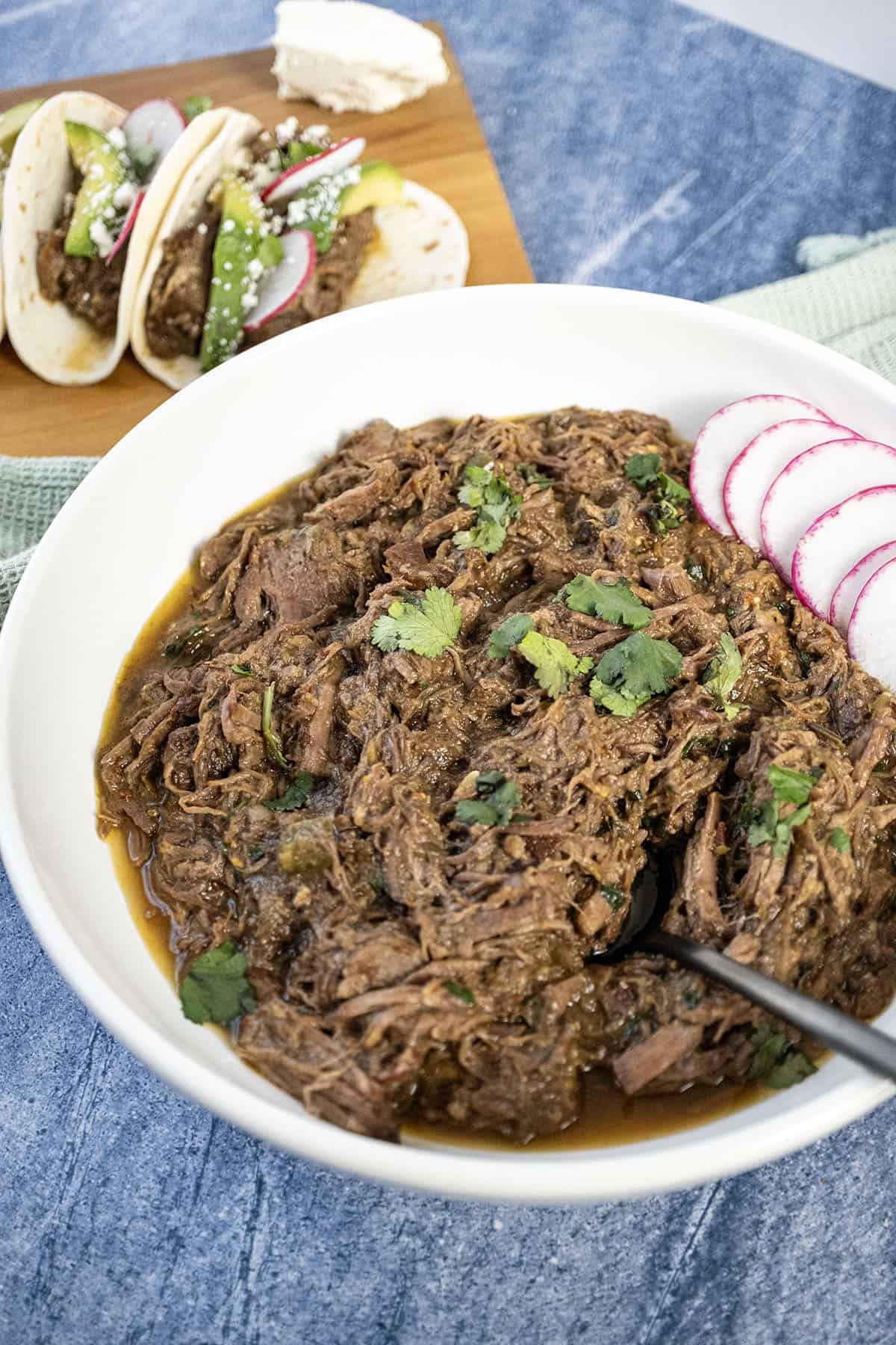 Barbacoa in a bowl topped with cilantro