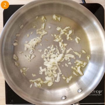 Sauteing onions in a pan.