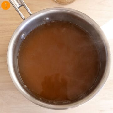 Warming chicken broth in a pot.