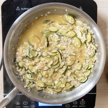 Chicken broth added to saucepan.