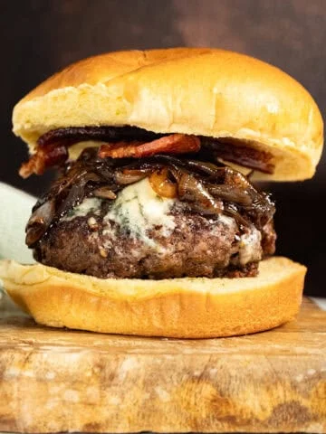 Bacon blue cheese burger on a cutting board.