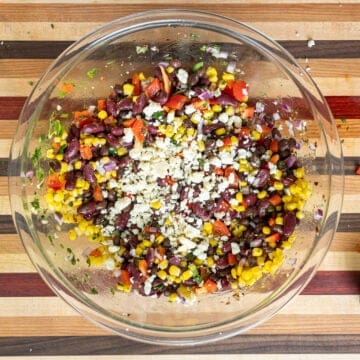 Cheese and dressing added to bean salad.