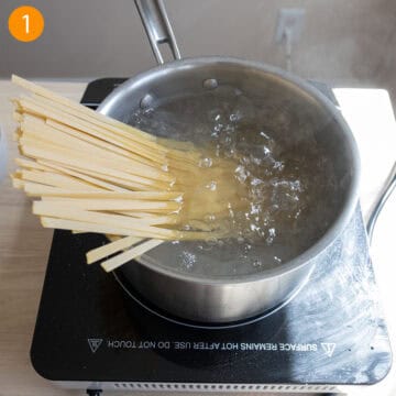 Boiling fettucine in a pot.