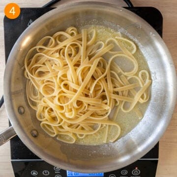 Combining pasta with the butter and pasta water.