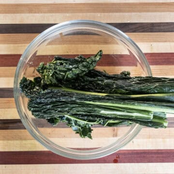 Massaging kale in olive oil.