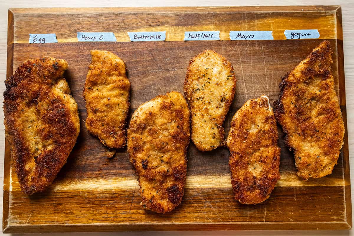 Chicken cutlets on a cutting board, labeled with what they were battered in.