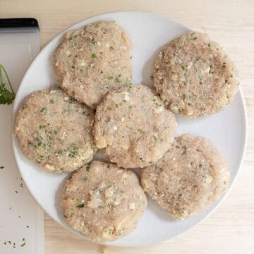 Ground chicken patties on a plate.