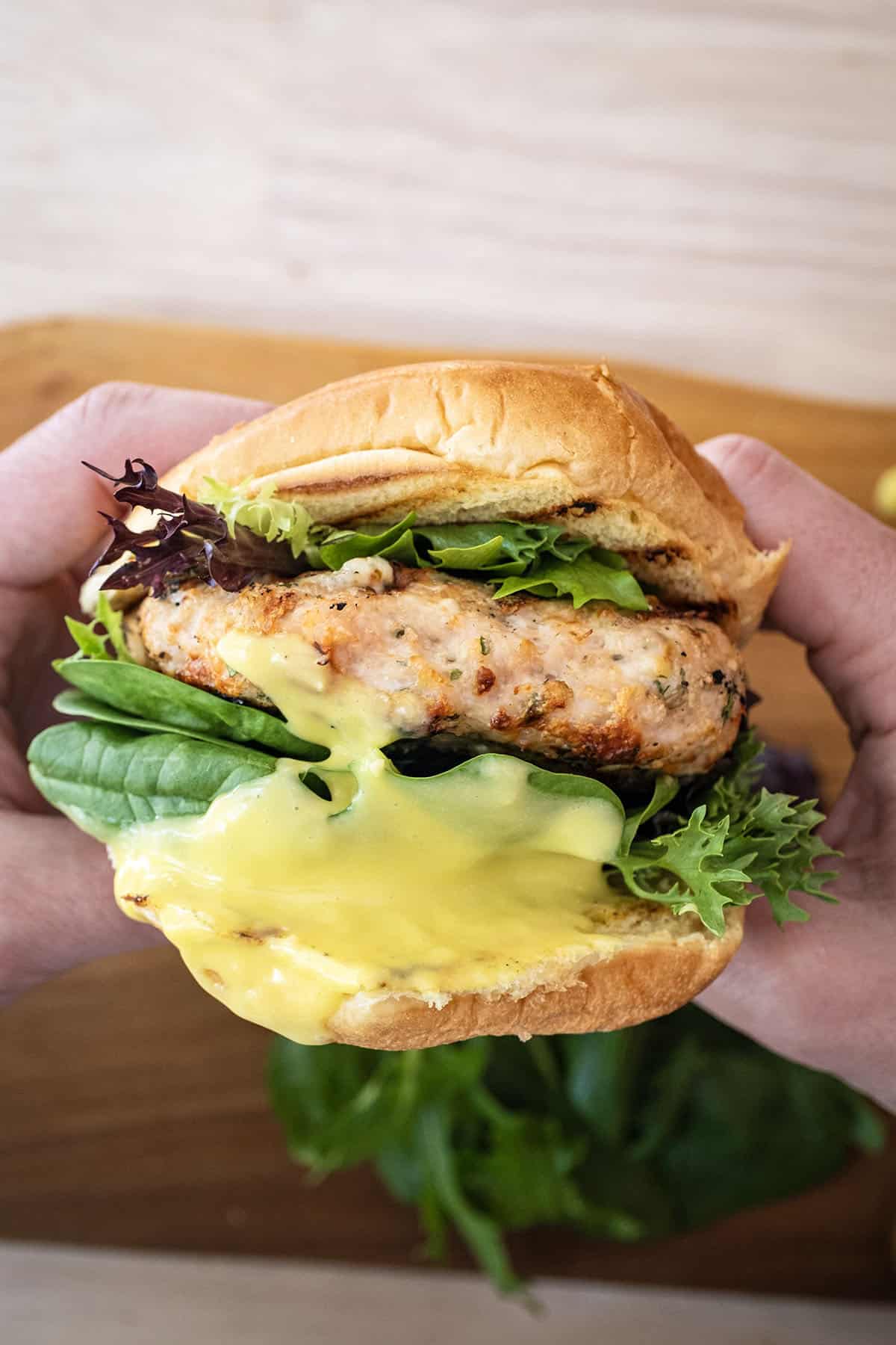 Grilled chicken burger on a bun with garlic aioli.