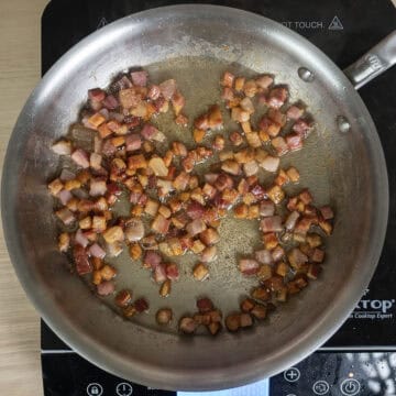 Fried pancetta in a pan.