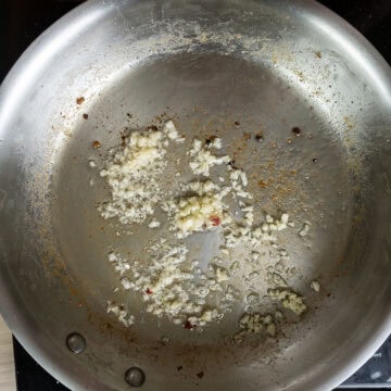 Sauteing garlic in a pan.