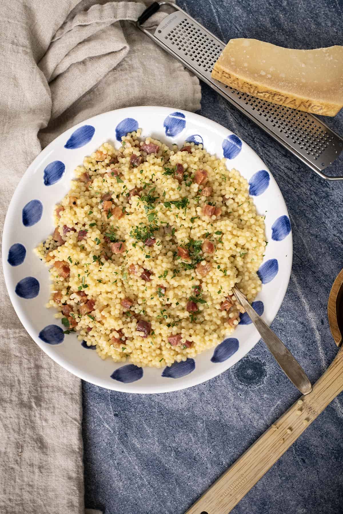 Pastina with pancetta and parsley in a bowl.