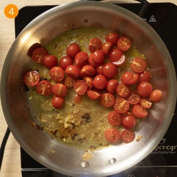 Cherry Tomatoes and white wine added to pan to simmer with garlic.