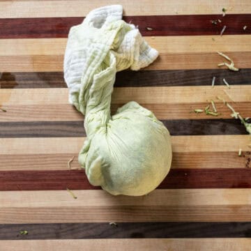 Grated zucchini in a cheese cloth.