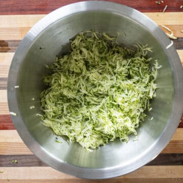 Grated zucchini in a bowl.