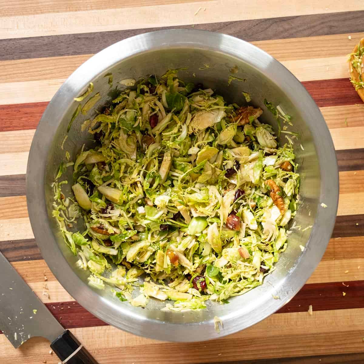 Combining the salad with dressing.