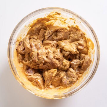 Chicken thighs marinated in chipotle mayo and seasoning.