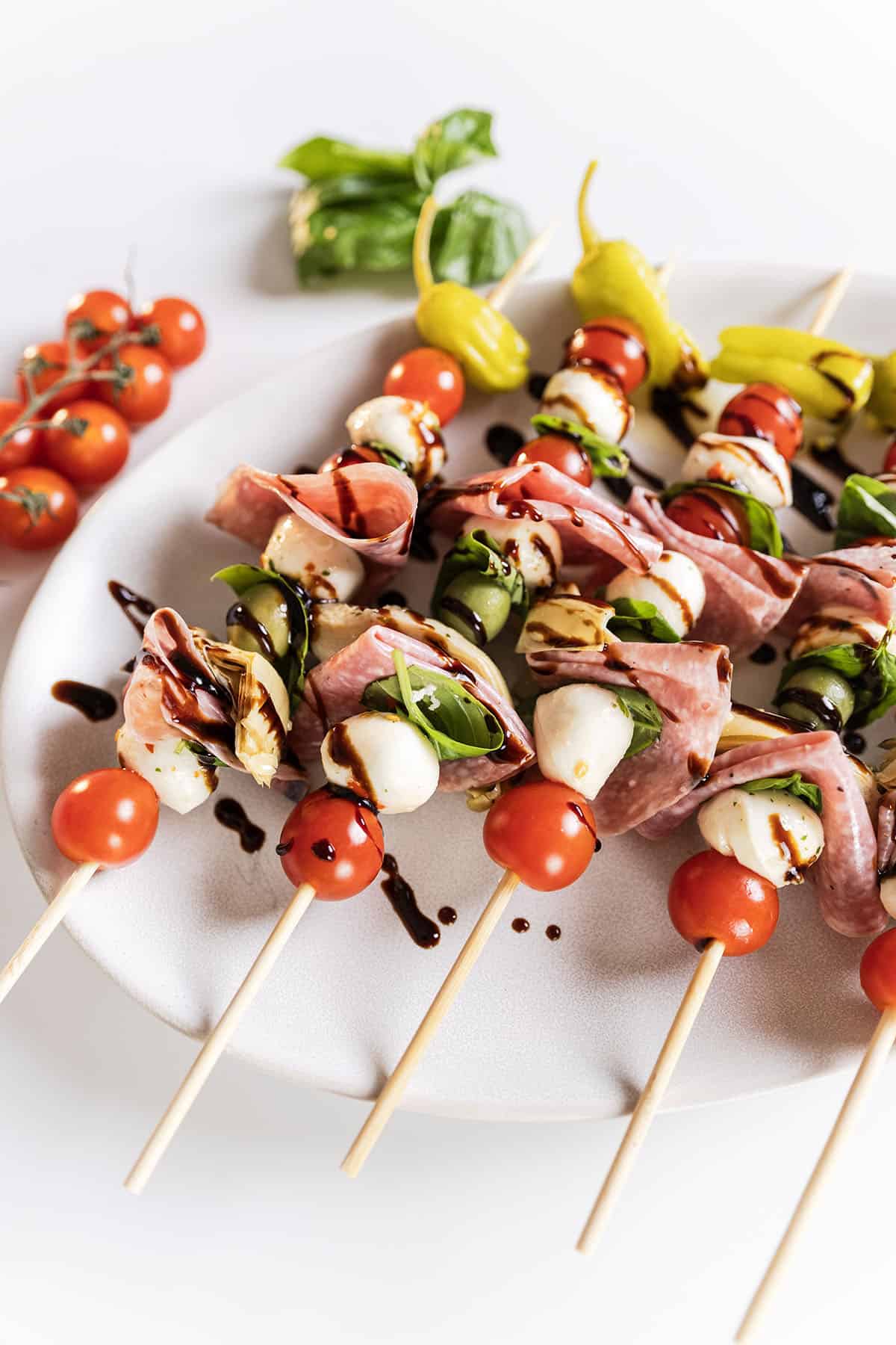Caprese skewers on a plate.