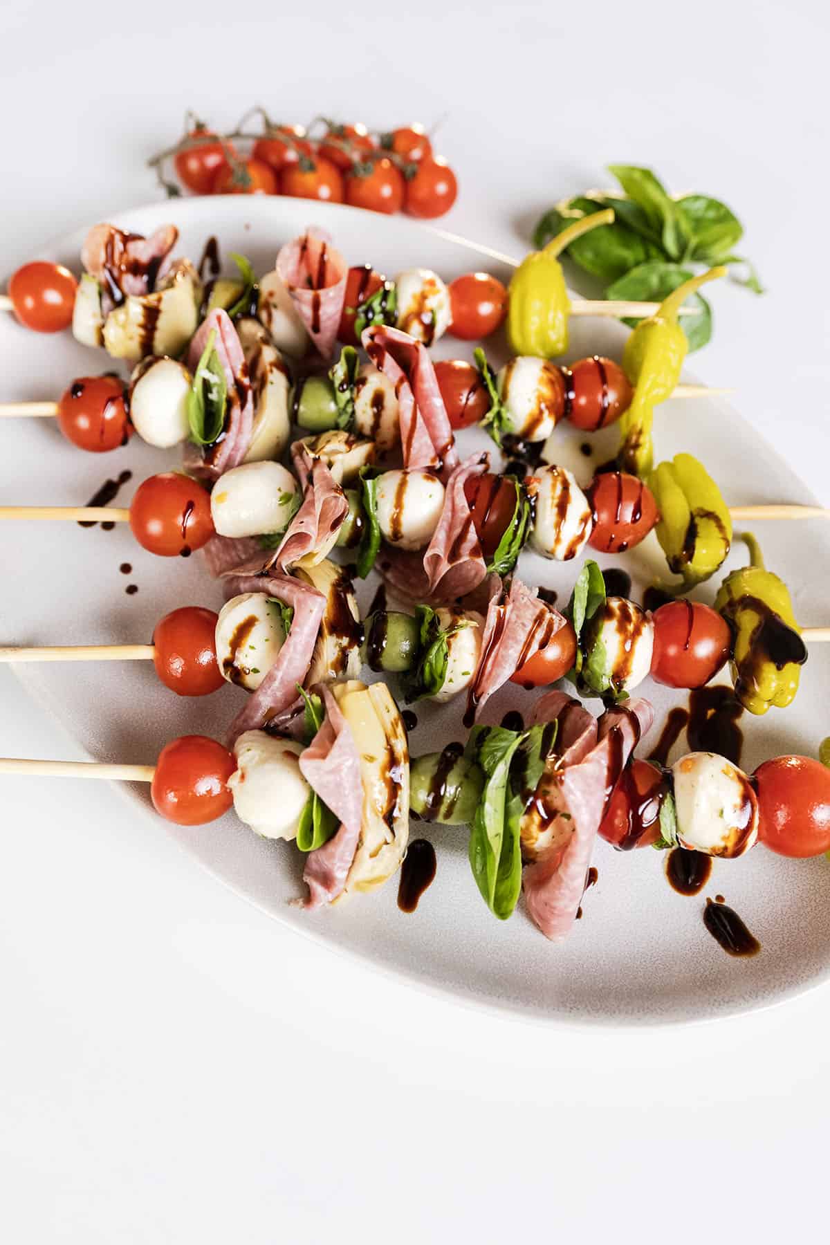 Caprese skewers on a plate.