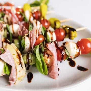 Caprese skewers on a plate.