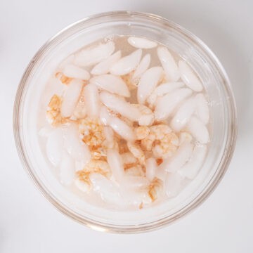 Blanching shrimp in an ice bath.