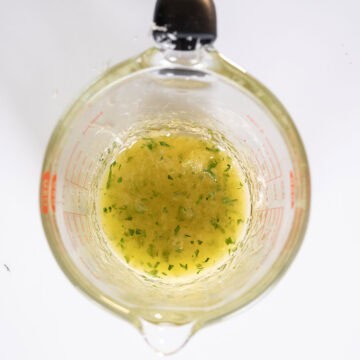 Lemon garlic butter sauce in a measuring cup.