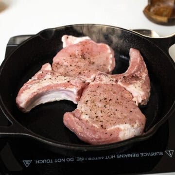 Searing pork chops in a cast iron.