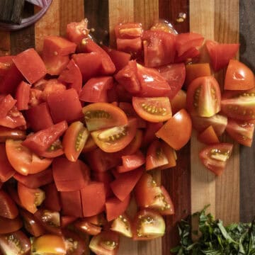 Chopped tomatoes on a cutting board.