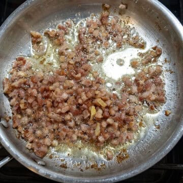Frying pancetta in a saucepan.
