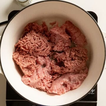 Searing ground beef and ground pork in a pot.