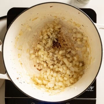 Sauteing onions in a pot.