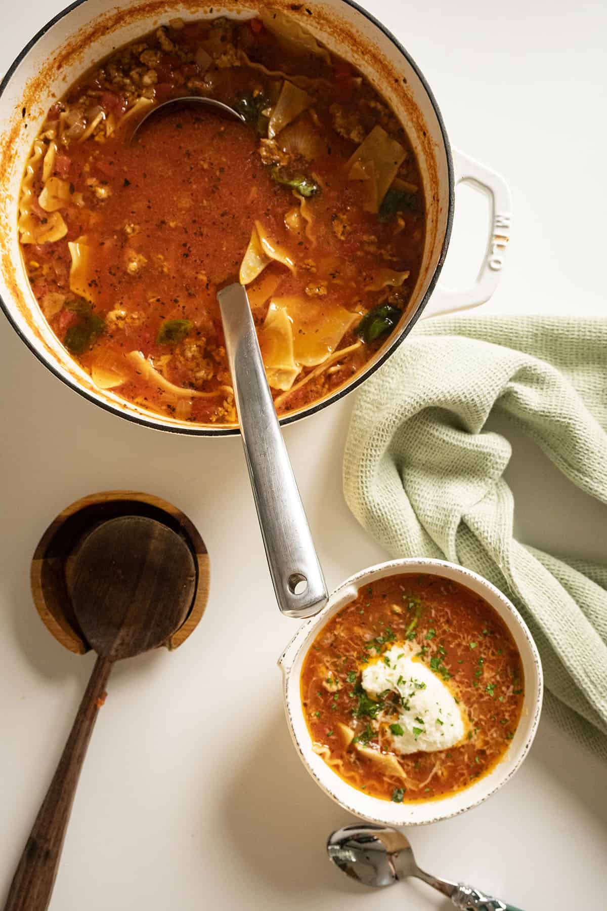 Lasagna soup in a pot and a bowl.