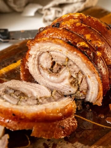 Rolling and tying porchetta from the outside in.