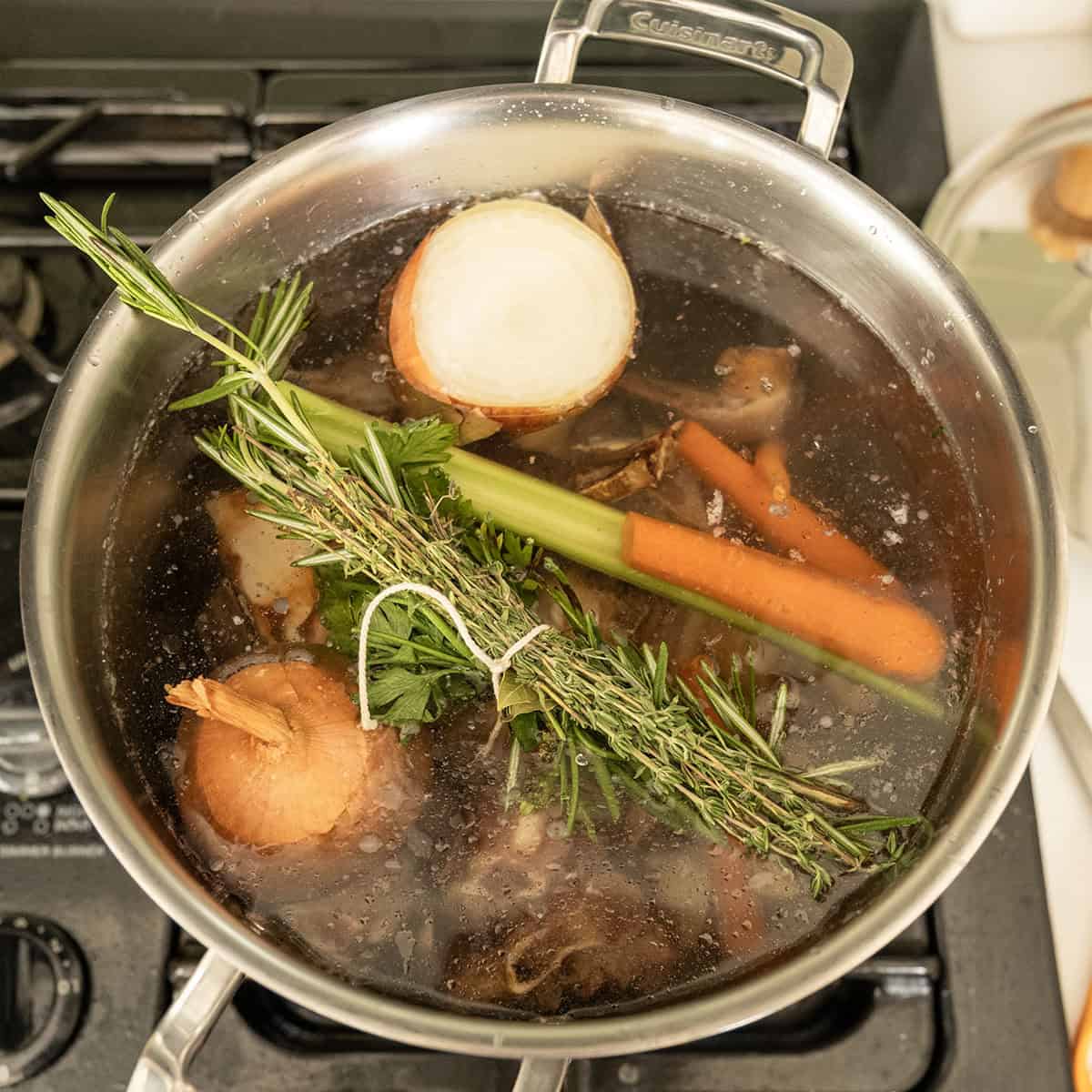 Simmering beef and vegetables in a pot.
