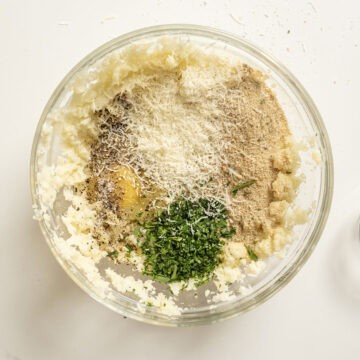 Egg, breadcrumbs, parmesan, parsley, salt, and pepper combined with mashed cauliflower.