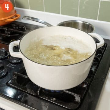 Boiling potatoes in a pot of water.