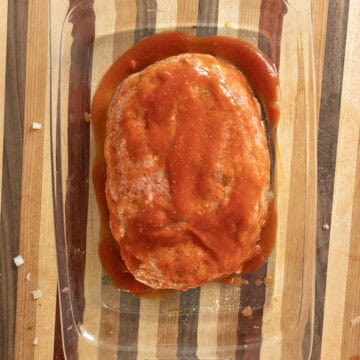 Meatloaf covered in tomato sauce.