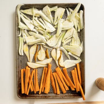 Fennel, carrots, and pears on a baking pan.