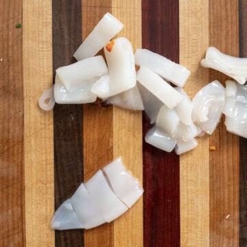 Slicing squid tubes.