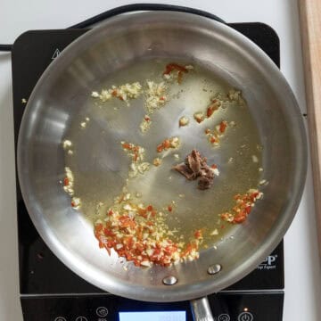 Sauteing garlic, chile pepper, and anchovies.