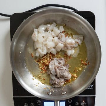 Sauteing calamari with garlic, chiles, and anchovies.