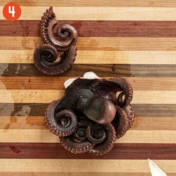 Cutting octopus on cutting board.