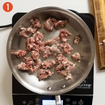 Searing sausage in a saucepan.