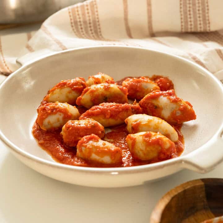 Stuffed calamari in tomato sauce on a plate.
