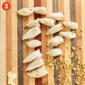 Stuffing the calamari on cutting board.