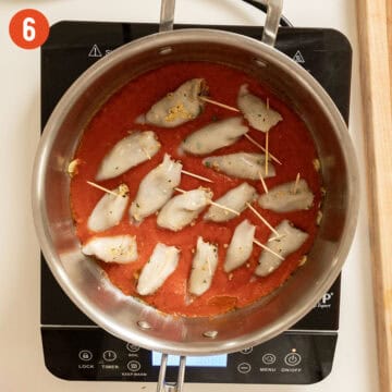 Simmering calamari in tomato sauce.