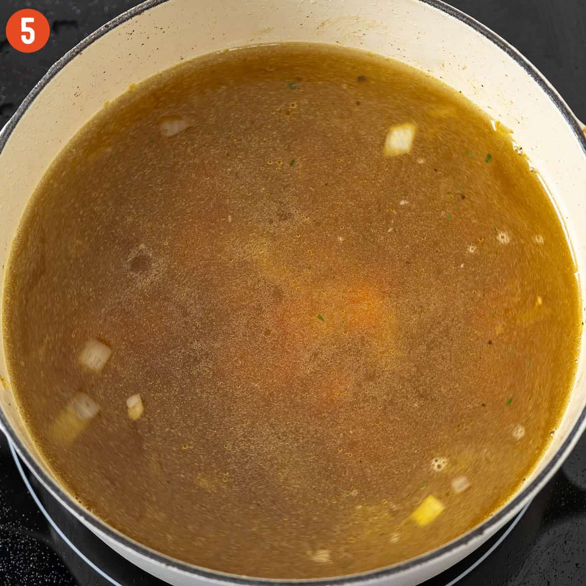 Simmering soup in a pot.