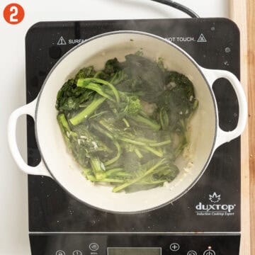 Sauteing broccoli rabe in dutch oven with garlic.